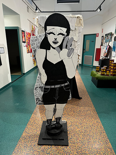 Lifesize cutout of a caricature displayed in a room.