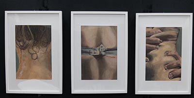 Three paintings are each framed in a white photo frame.