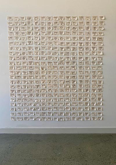 The artwork is displayed on a white wall.