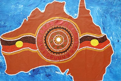 Painting of a map of Australia featuring Indigenous art.