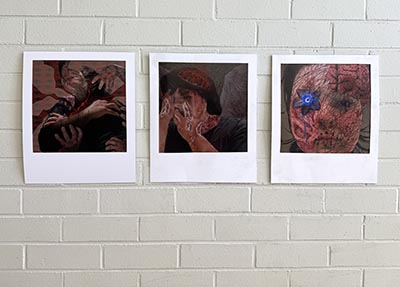 Three images printed on white paper, displayed on a beige brick wall.