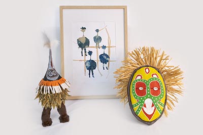 The installation features two sculptures positioned in front of a framed artwork.