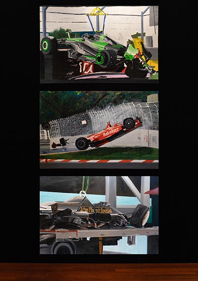 An artwork featuring three paintings of high-speed race car crashes, arranged vertically against a black background.
