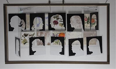 Natural elements like flowers can be viewed through an art frame filled with silhouettes of people.