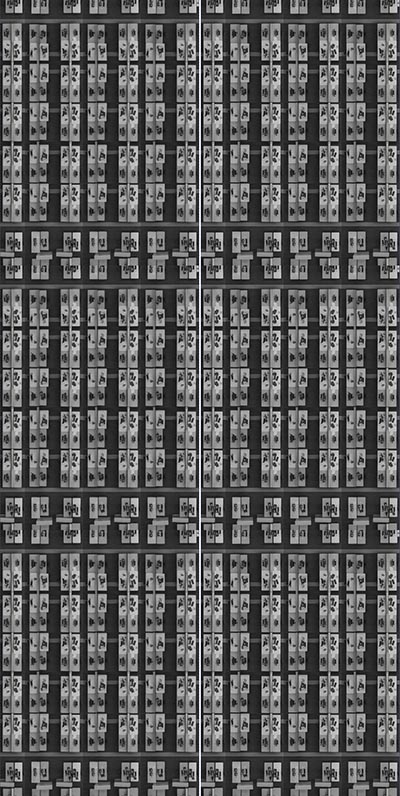 An artwork depicting repetitive greyscale imagery of an office.