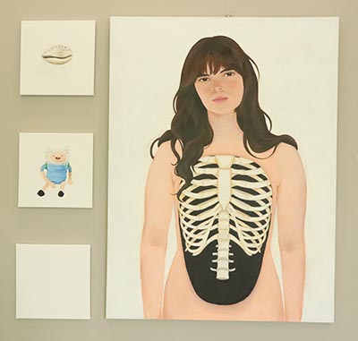 A large portrait painting featuring ribs in a black, hollow chest-like space. To the left, three smaller paintings are displayed vertically: the top one depicts a seashell centred on the canvas, followed by a plush toy, and finally, a blank canvas.